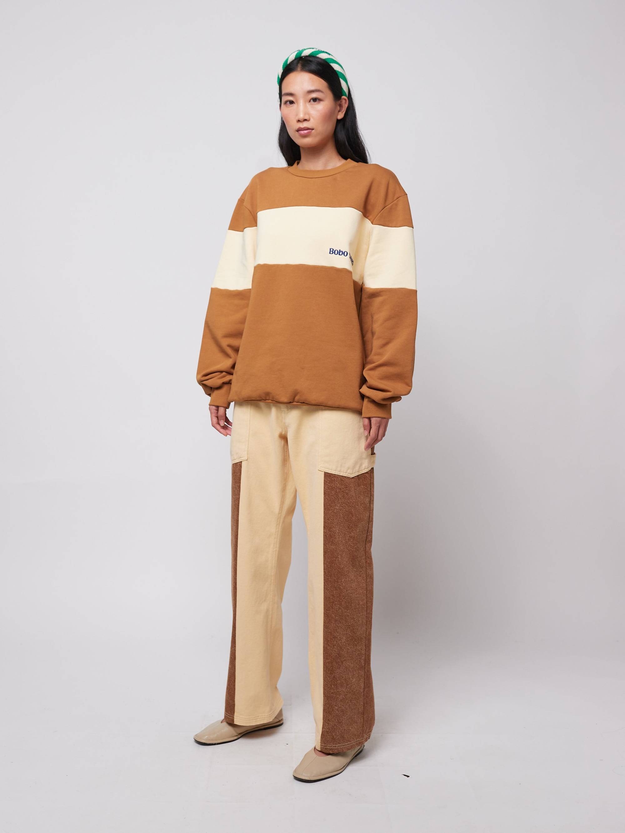Frau trägt Color Block Relaxed Jeans von Bobo Choses in Beige und Braun mit weitem Schnitt, ideal für Damenmode Frühjahr/Sommer 2025.