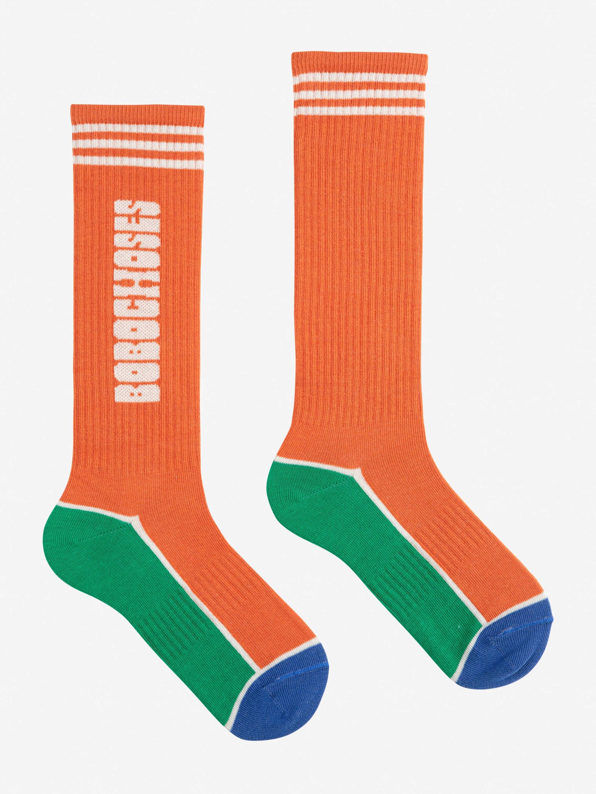 Bobo Choses color block extra long socks in Orange mit grün-blauen Farbakzenten und weißem Logo, ideal für Kinder und Teenager.