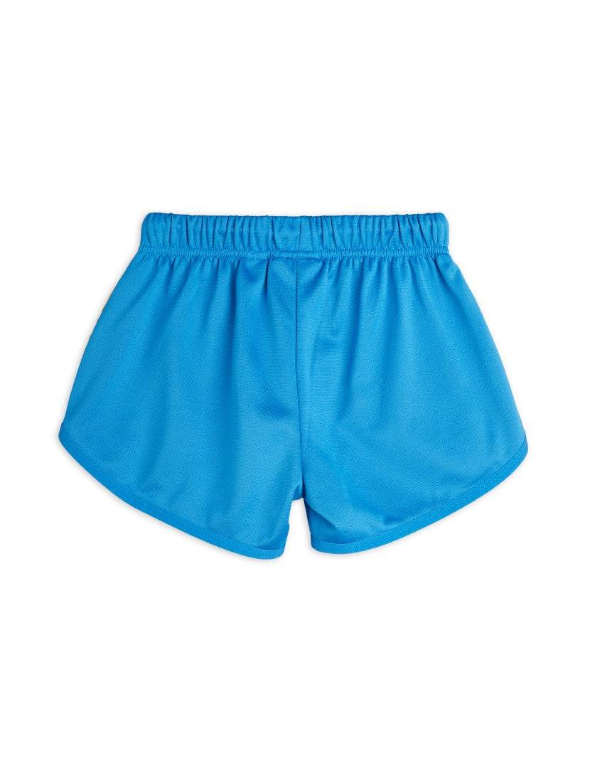 Rückansicht der blauen WCT Shorts für Kinder, aus leichtem Material mit lockerem Schnitt für hohen Tragekomfort in der Kategorie Hosen & Shorts.