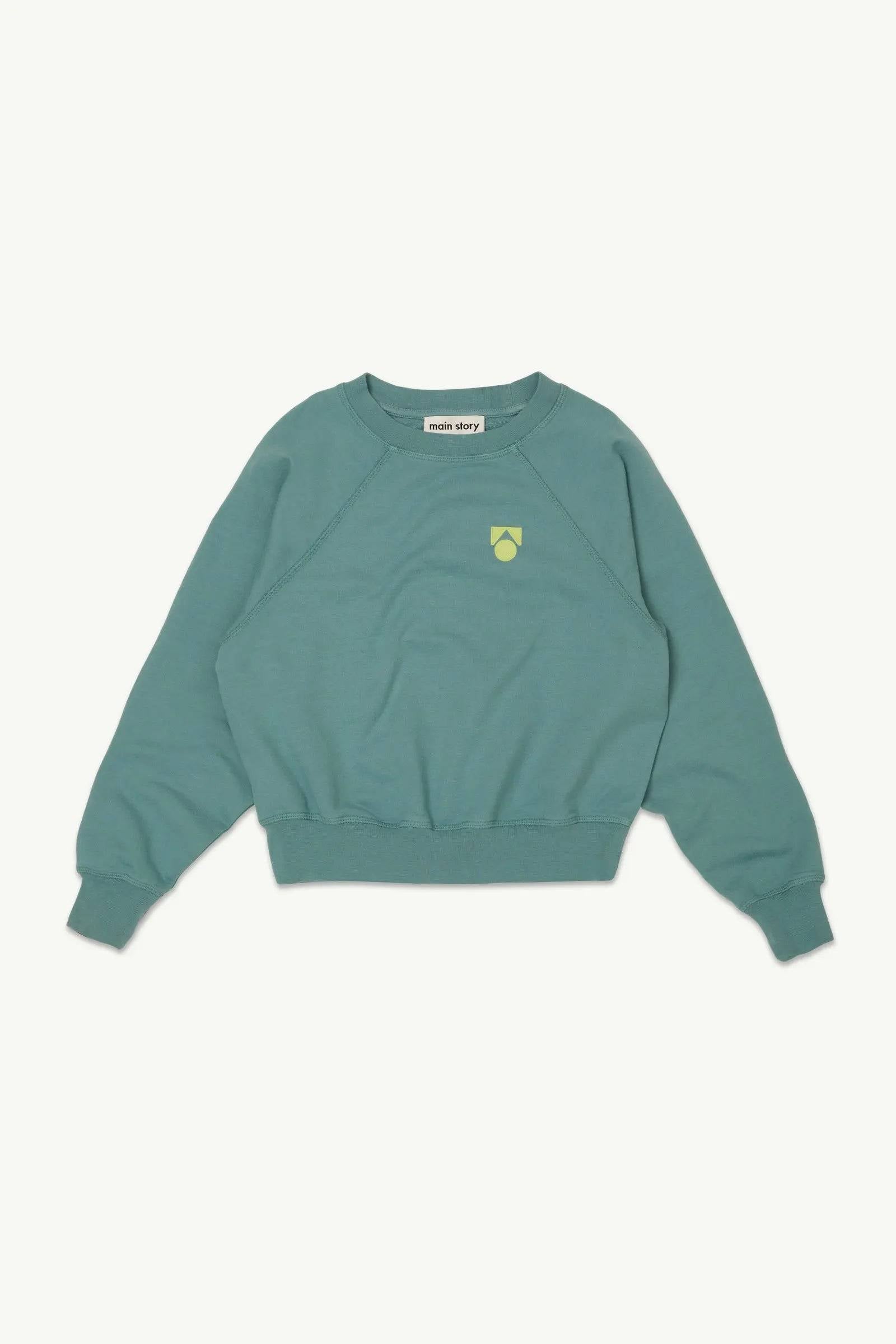 Raglan Sweat Smoke Blue Fleece Pullover für Kinder mit gelbem Logo auf der Brust, weiches Material und lockerer Schnitt für Jungen und Mädchen.