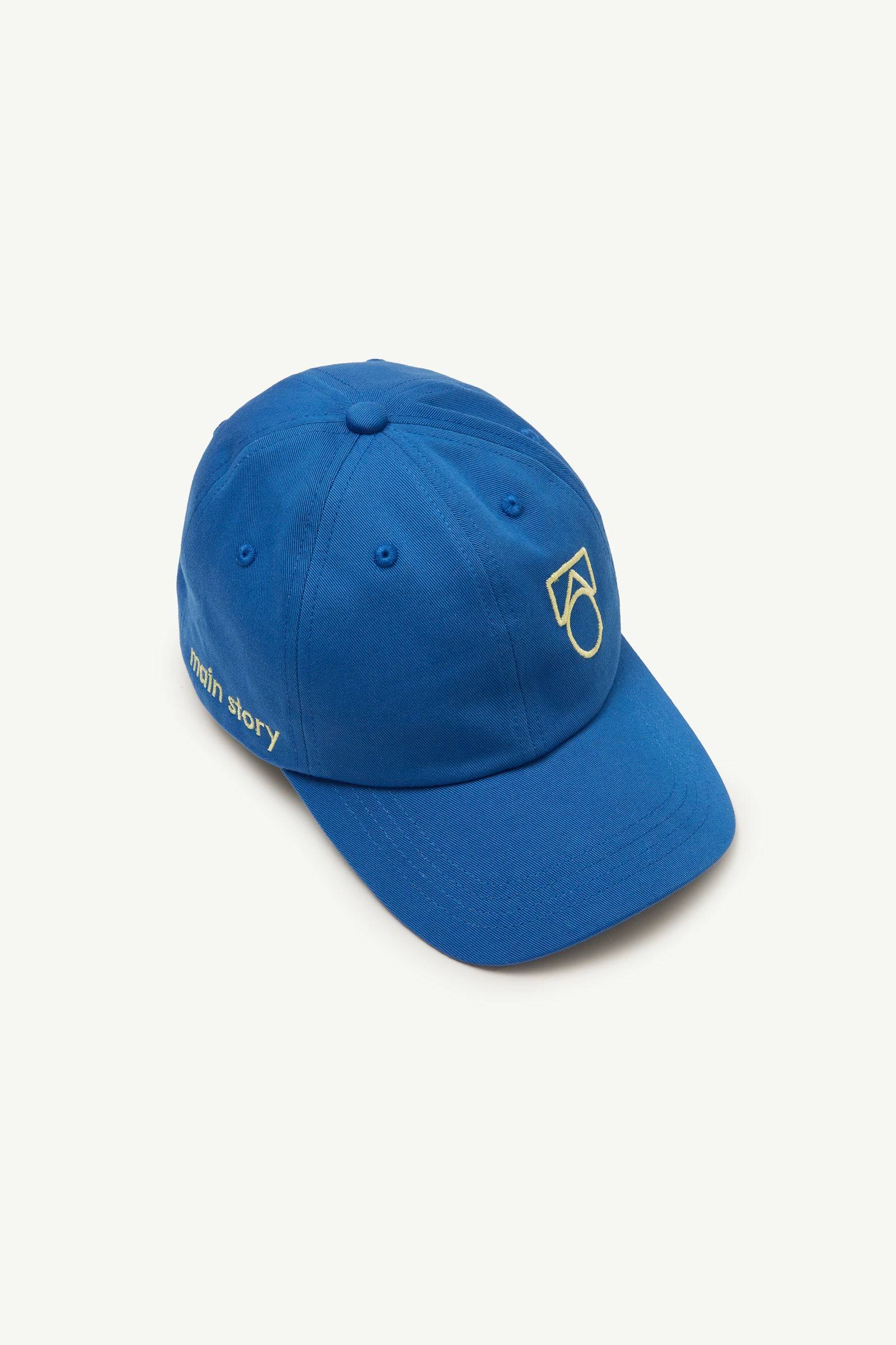 Cap Blue Twill aus Baumwolle mit gesticktem Logo vorn und 'main story'-Schriftzug an der Seite, ideal für Jungen und Mädchen.