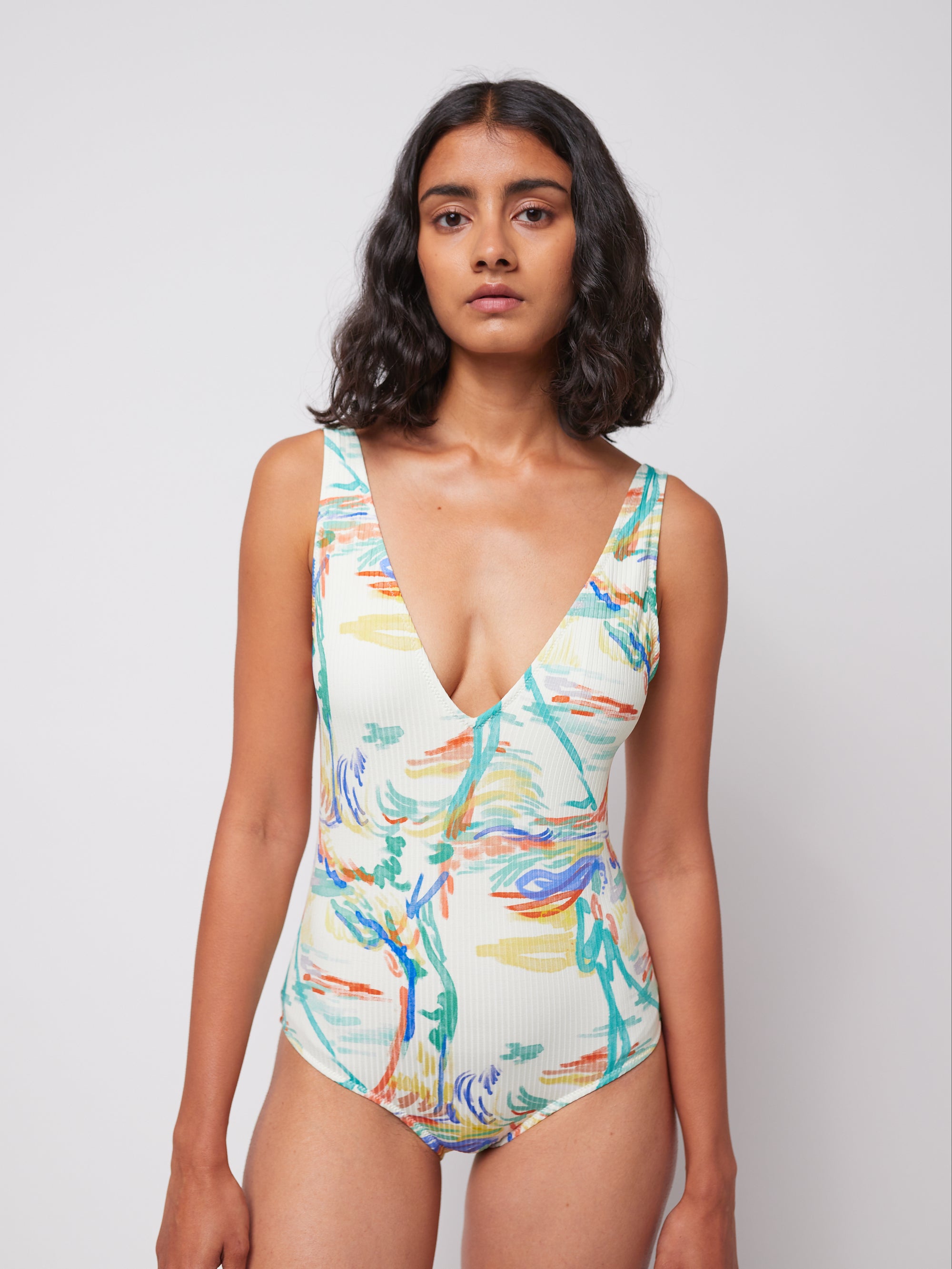 Close-up of Spring Landscape Swimsuit with ribbed V-neck and artistic print. A sustainable and fashionable swimwear option for women.