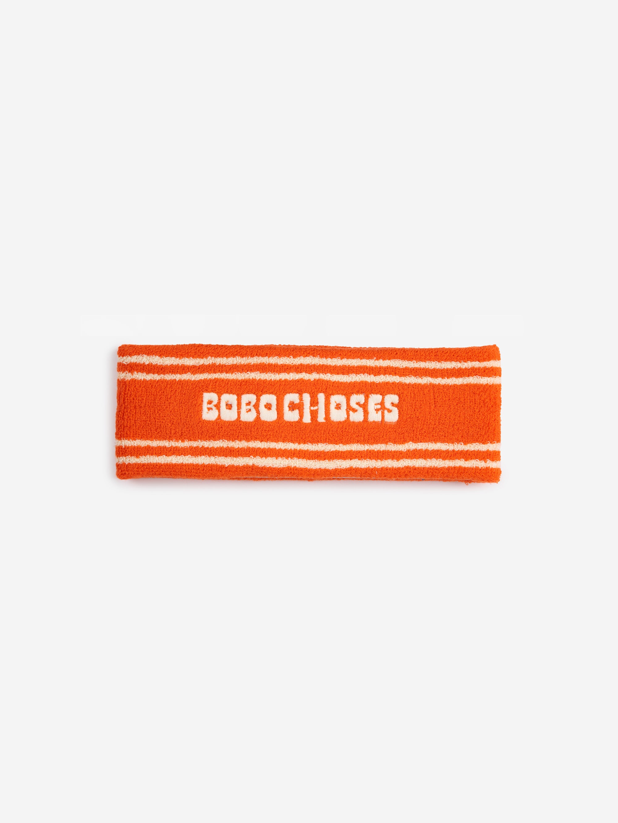 Bobo Choses Orange Terry Towel Headband, a stylish and absorbent headband with white embroidered branding and stripe details, made in Spain.