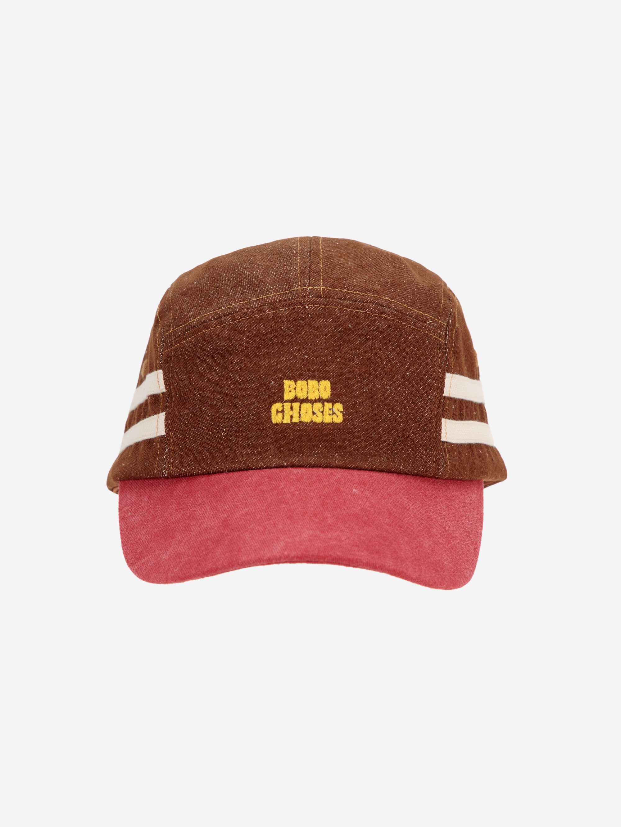 Front view of Bobo Choses cap featuring a brown canvas design, red brim, and yellow embroidered logo. A trendy and durable accessory for any outfit.