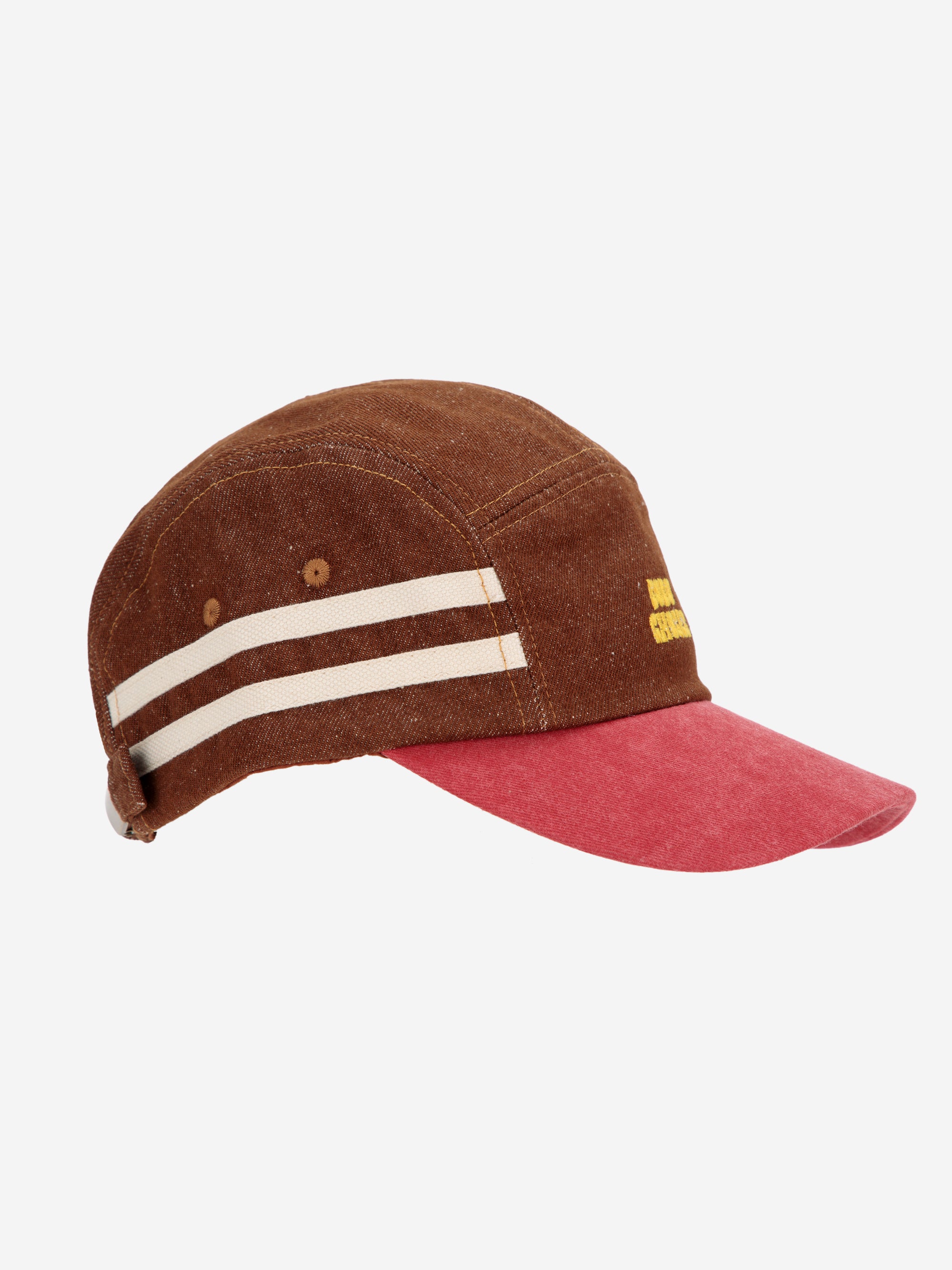 Side view of Bobo Choses cap showcasing striped side details, brown canvas fabric, and red brim. A stylish and functional hat for everyday wear.