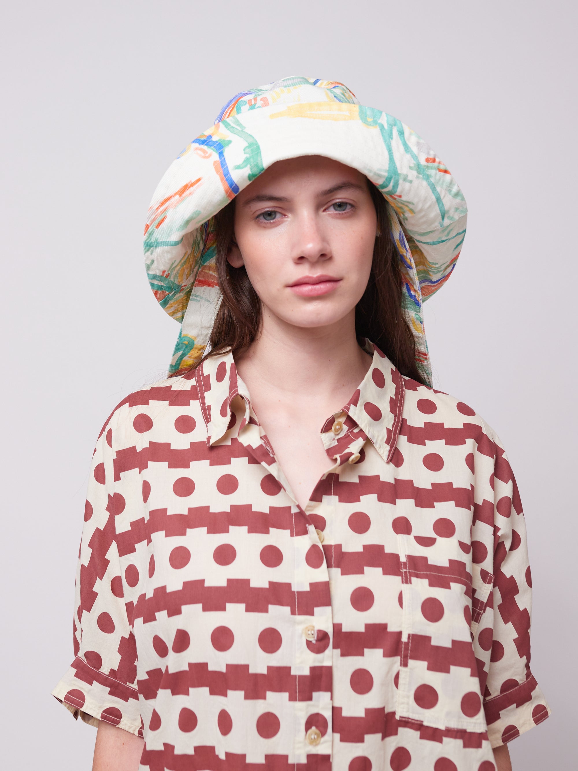 Model wearing a Landscape Print Canvas Hat with a relaxed fit. A fashionable and practical choice for sunny days.