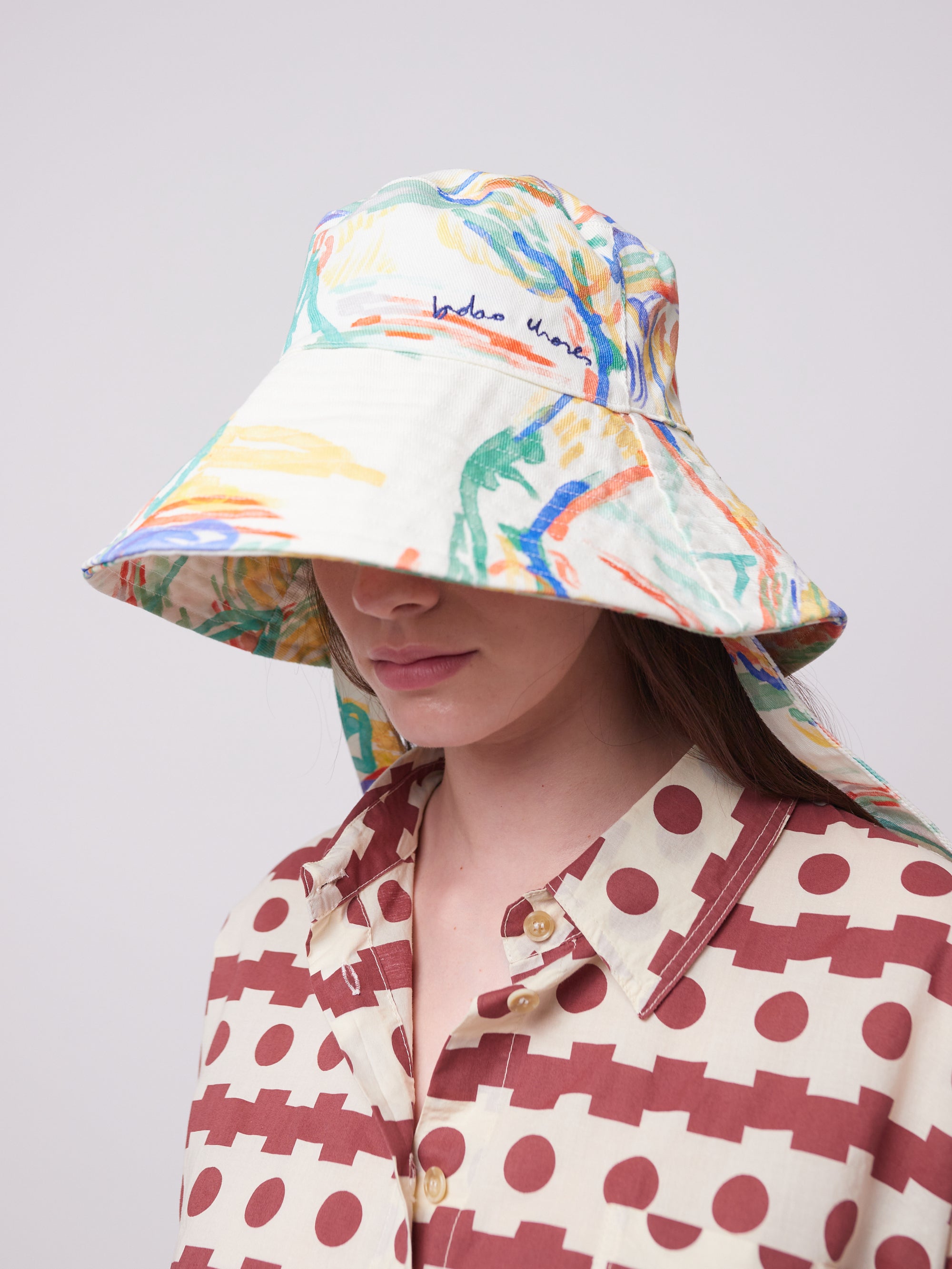 Stylish Landscape Print Canvas Hat with a wide brim, worn by a model. Durable and functional, perfect for outdoor adventures.