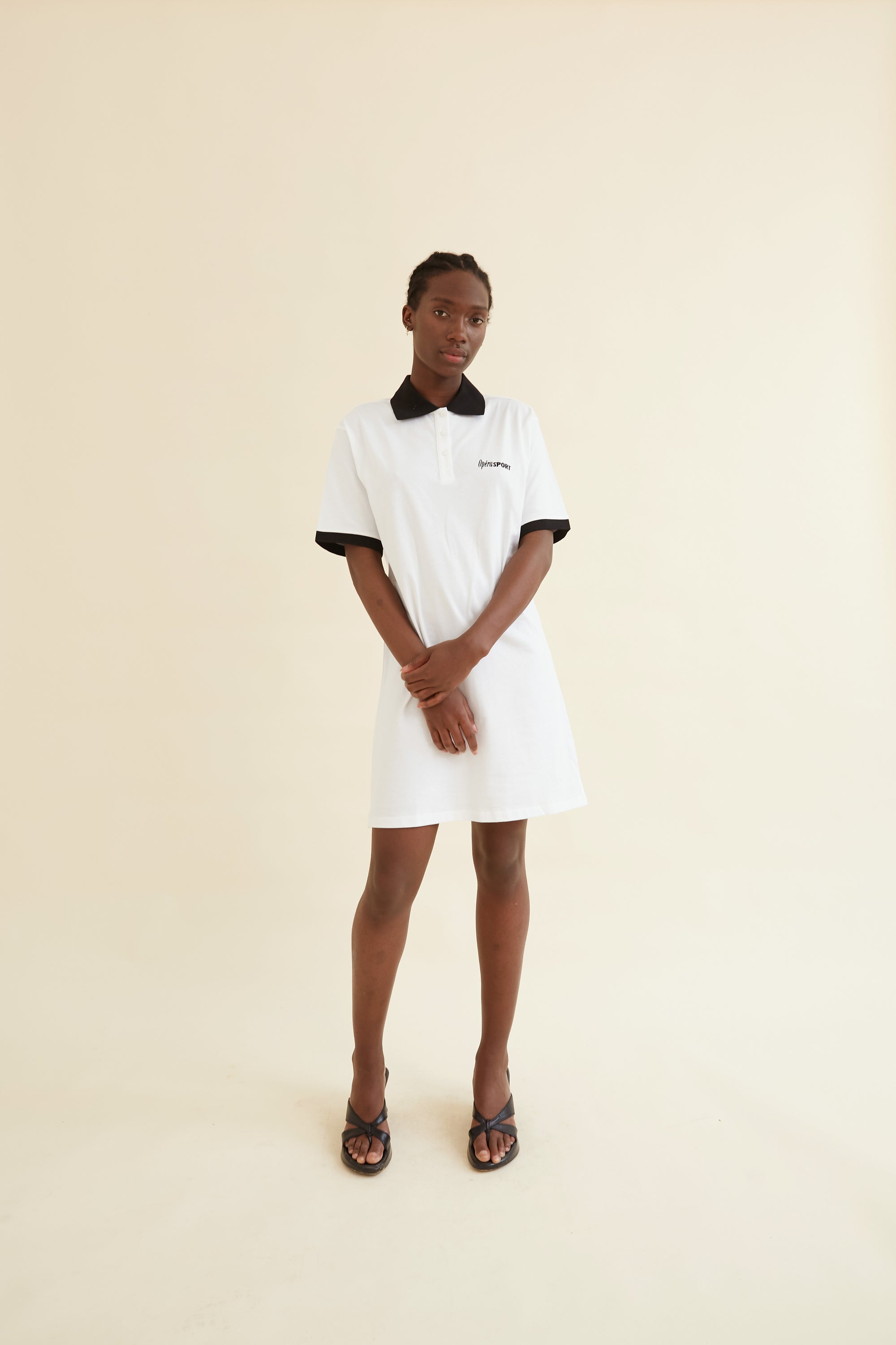 Josephine Polo Dress in white with black collar and sleeve trim, featuring a relaxed fit and short sleeves for a stylish yet comfortable look.