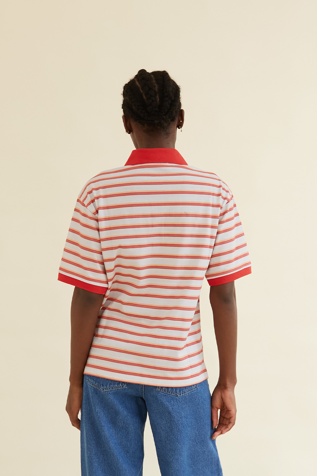 Back view of Luna Unisex Polo T-Shirt showcasing red and white striped design with red collar and sleeve trim. A versatile and comfortable wardrobe essential.