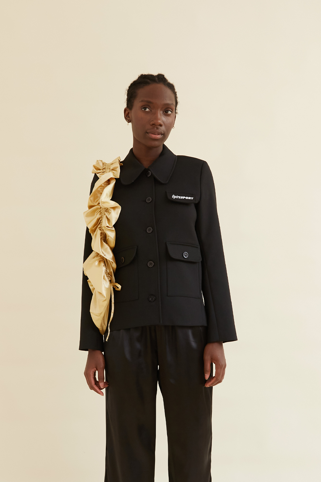 Black tailored jacket with gold ruched shoulder detail by OpéraSport. Features button-up front, flap pockets, and structured fit for a chic look.